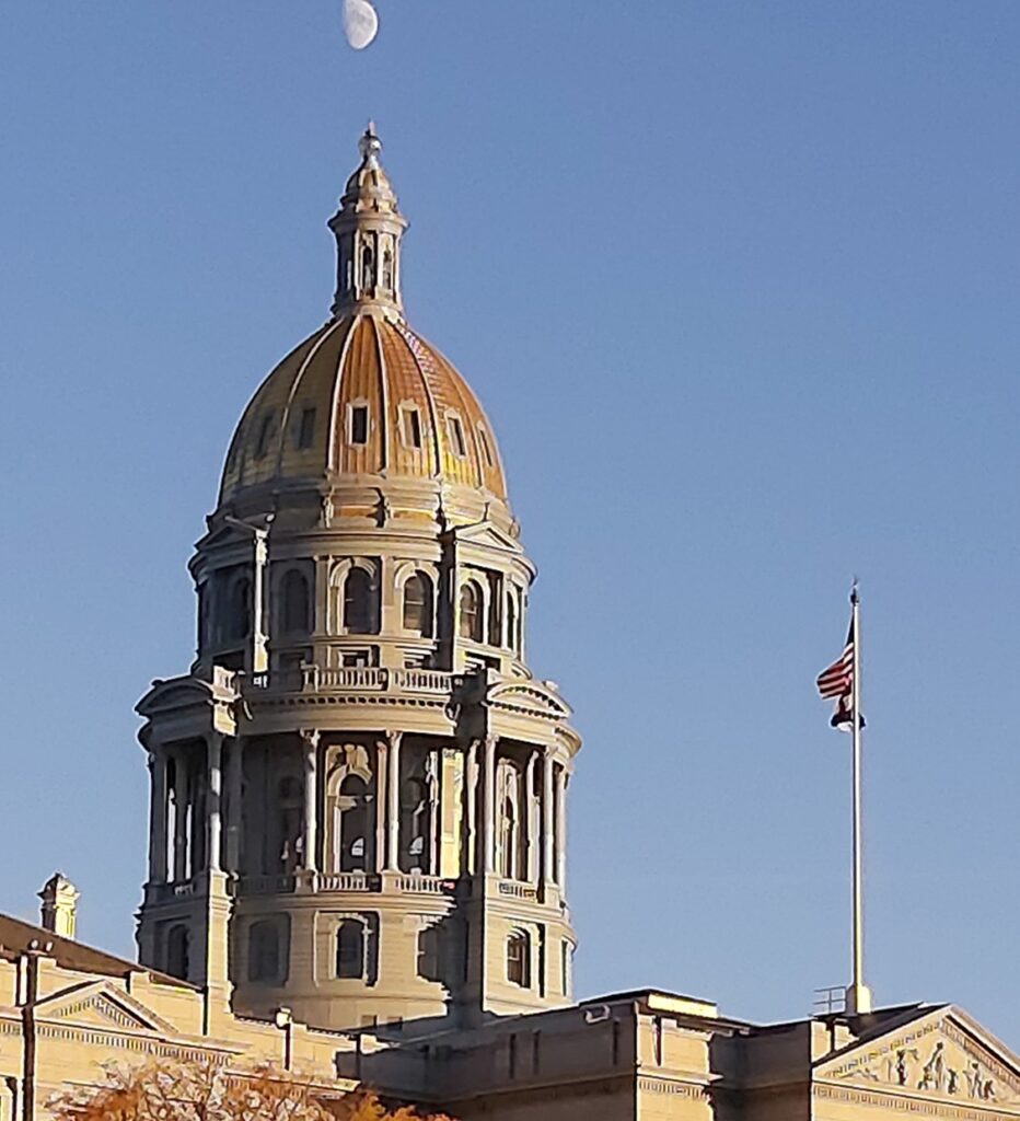Top of Colorado State Capitol building with observation deck and gold-plated dome.